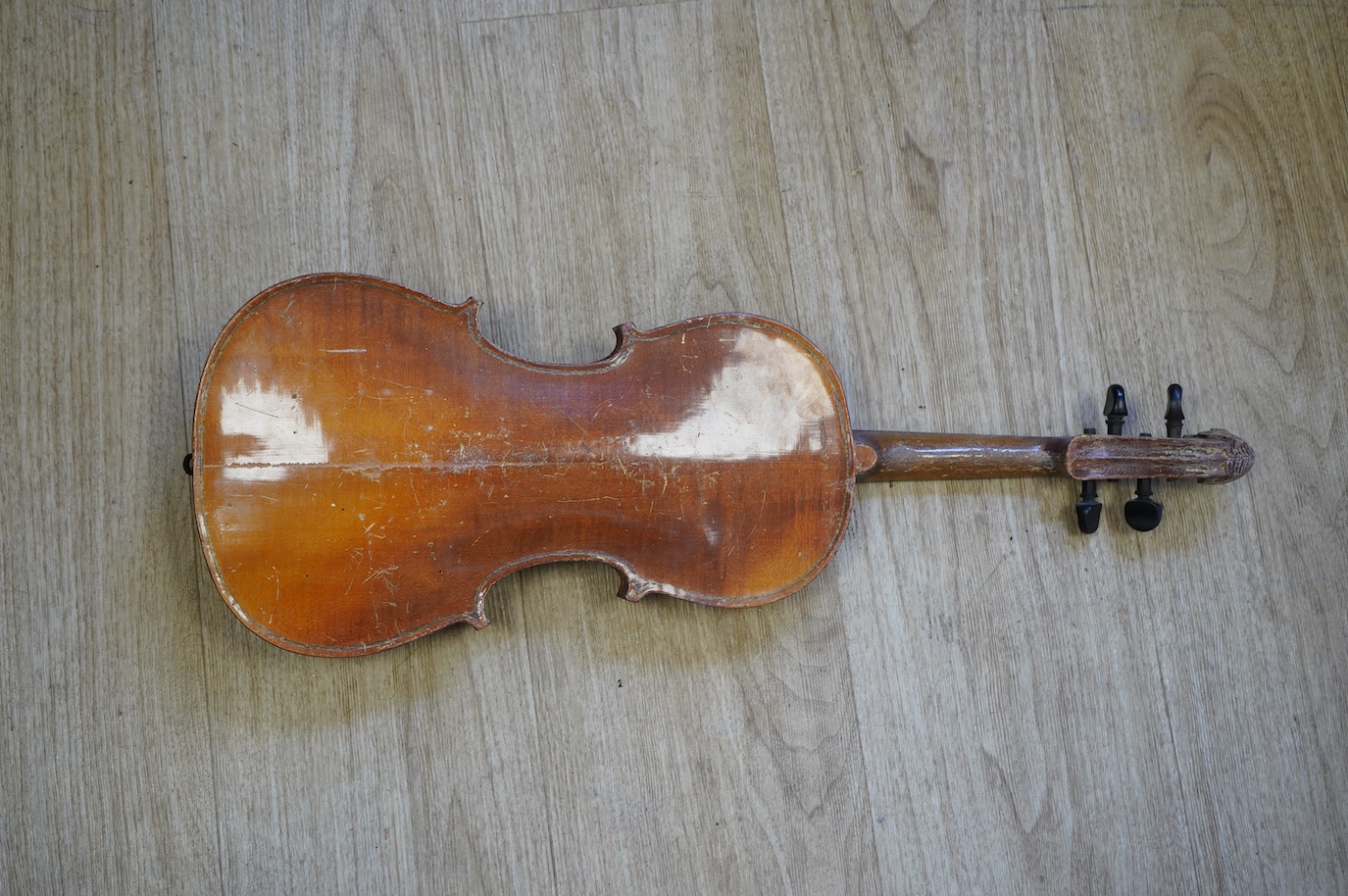 A student’s Golden Strad ‘cello imported by Boosey and Hawkes, body 69.5cm and violin, body 36cm, and a wooden conductors baton. Condition - poor to fair